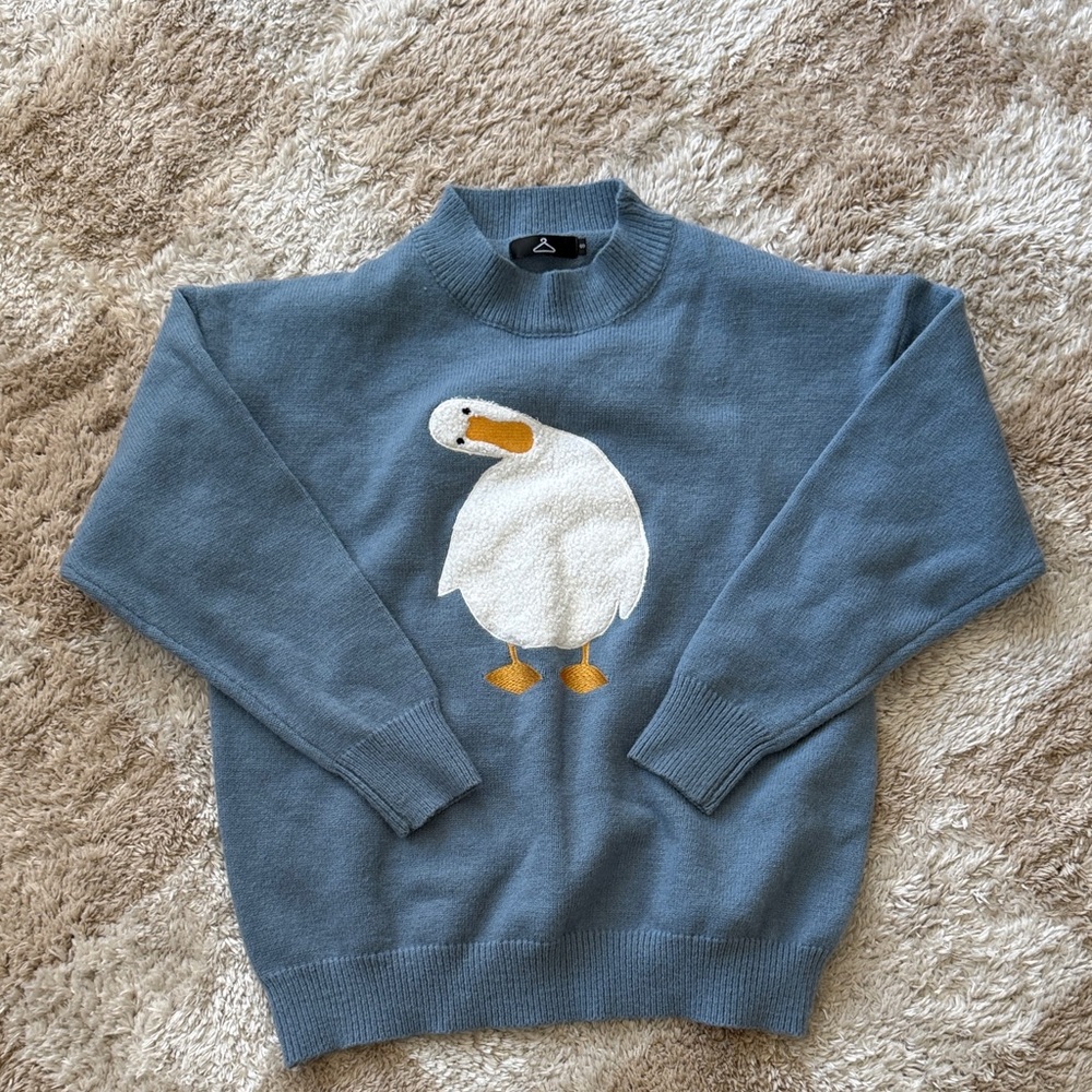 Blue tilted head duck sweater
